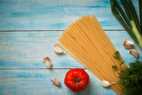 Uncooked spaghetti on the blue — Stock Photo, Image