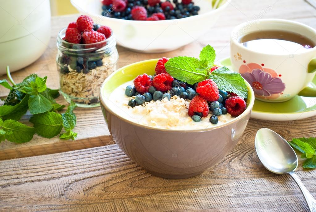 Healthy breakfast oatmeal with berries Stock Photo by ©Nadianb 80047678