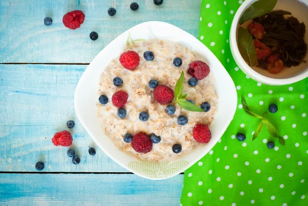 Oatmeal with different berries — Stock Photo, Image