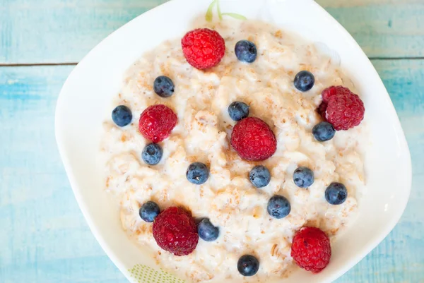 Oatmeal with different berries — Stock Photo, Image
