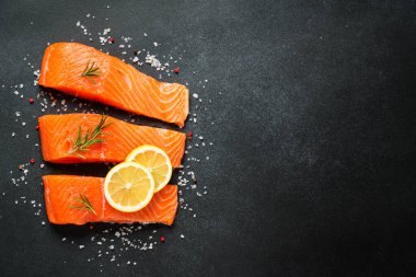 Somon fileto, siyah masada çiğ balık. Metin için boşluk olan üst görünüm.