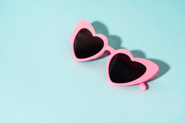 Renkli arka planda kalp şeklinde gözlük. Güneş gölgeleri.