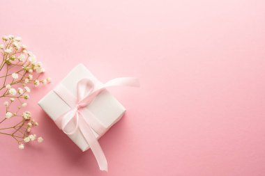 Pembe üzerinde çiçekler olan hediye kutusu. Kopyalama alanı olan üst görünüm..