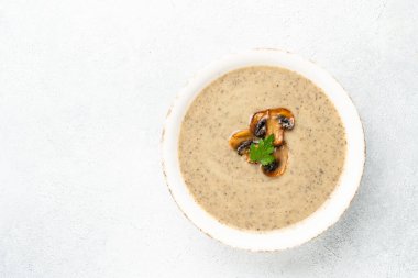 Beyaz mutfak masasında mantar çorbası püresi. Sağlıklı vejetaryen yemeği. Dizayn için alanı olan düz uzandı.