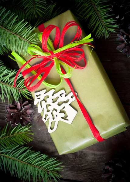 Christmas present with firtree branches — Stock Photo, Image