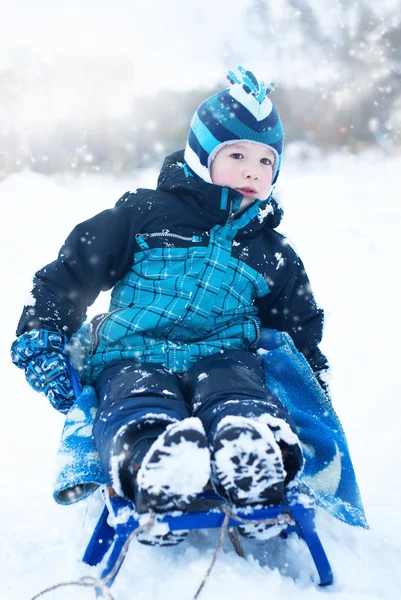 Happy boy sledding in winter — Stock Photo, Image