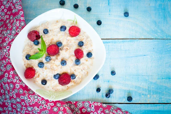 Oatmeal with different berries — Stock Photo, Image