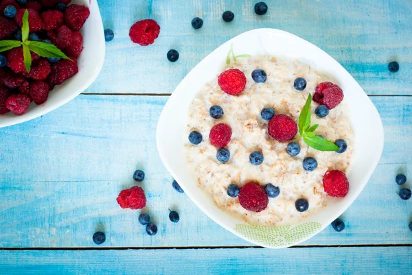 Oatmeal with different berries — Stock Photo, Image