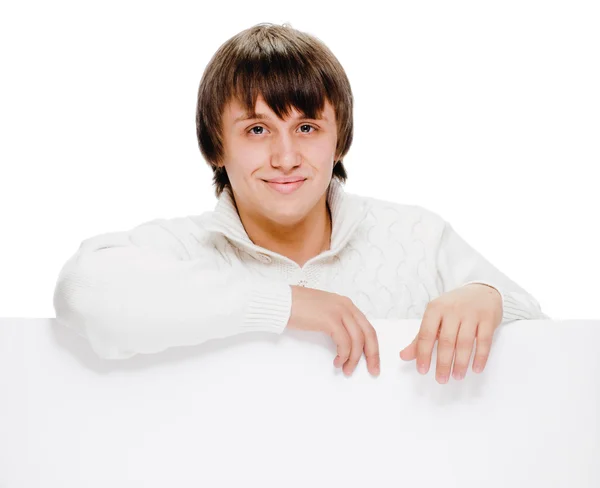 Young man with blank billboard — Stock Photo, Image