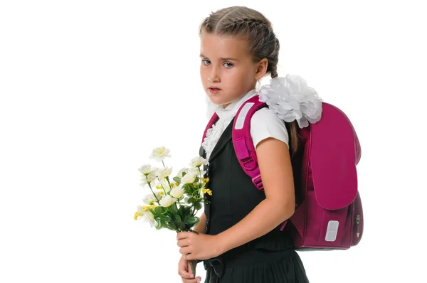 Malá školačka s květinami — Stock fotografie