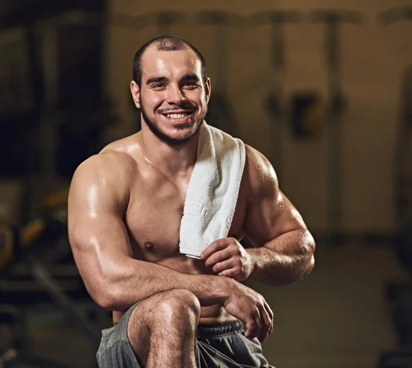 Handsome athlete with towel — Stock Photo, Image