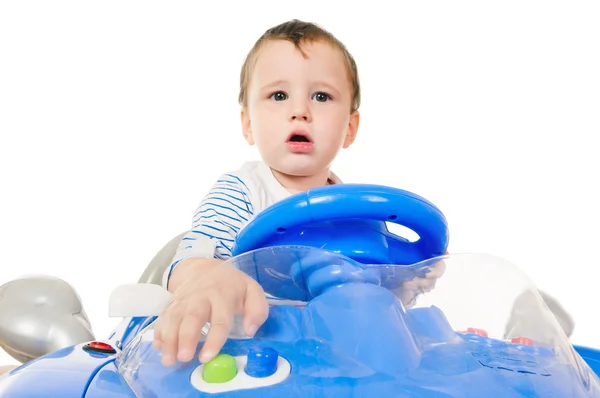 Kleine jongen rijden speelgoedauto Stockfoto