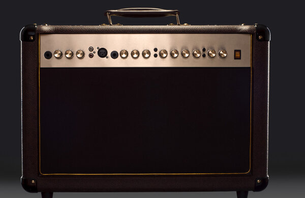 Acoustic guitar amplifier on the dark background