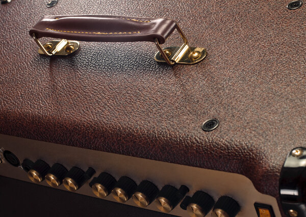 Handle on leatherette texture of an amplifier for electric guitar