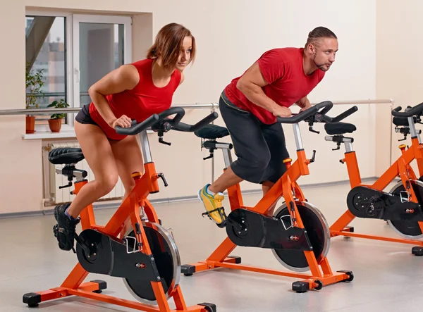 Indoor bycicle cycling in gym — Stock Photo, Image