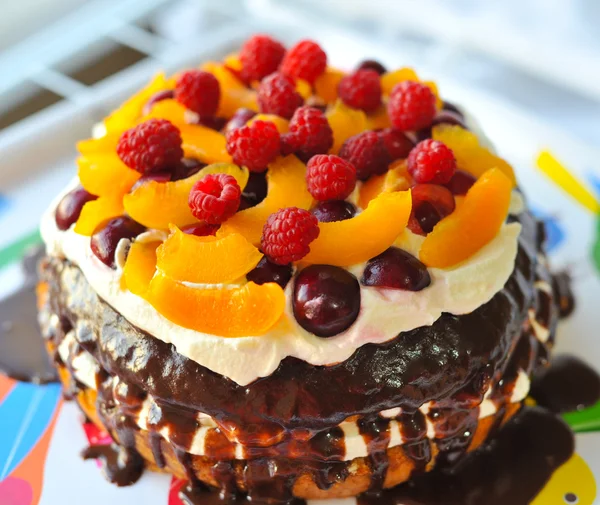 Cake with fruit, berries and butter cream, raspberry, peach, cherry