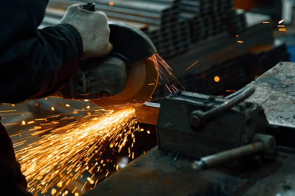 Cutting a metal beam using an electric hand saw.