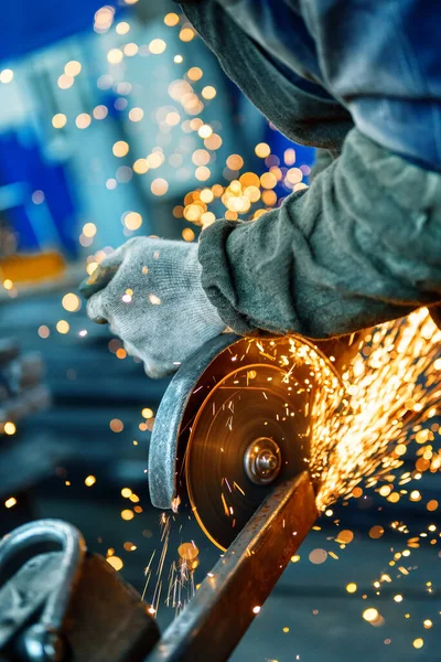 Cutting a metal beam using an electric hand saw.