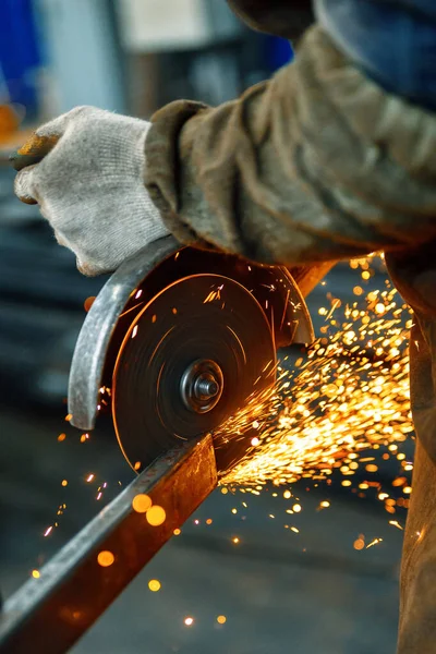 Cutting a metal beam using an electric hand saw.