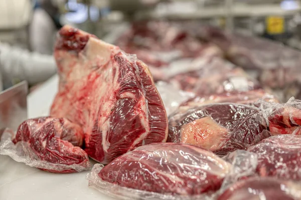 Large cuts of beef packed in a vacuum plastic bag.