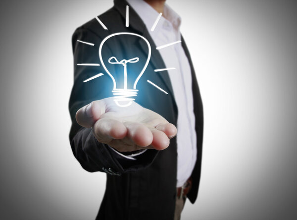  business person holding light bulb 