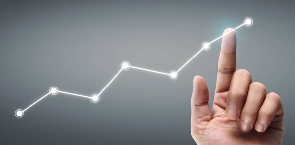 Hand touching a graphs of financial indicator and accounting market economy analysis chart