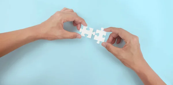 Holds in hand  jigsaw puzzle. Business solutions success and strategy concept