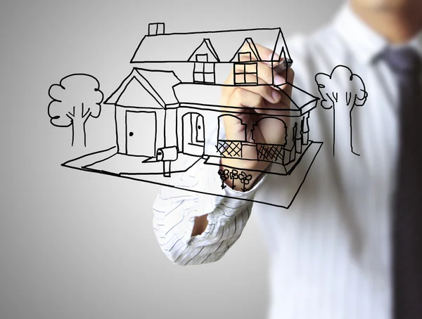 Hand tekenen huis in een whiteboard — Stockfoto