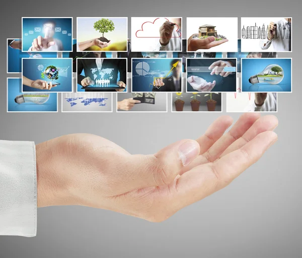 Businessman holding a screen with digital photos — Stock Photo, Image