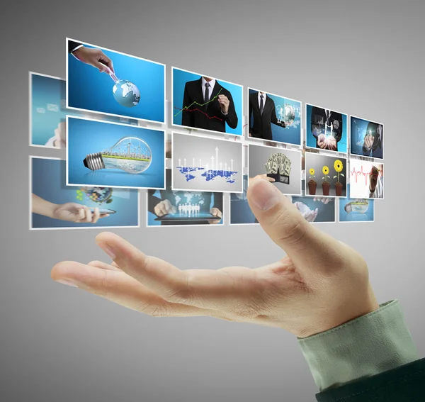 Man pushing on a touch screen digital photos — Stock Photo, Image