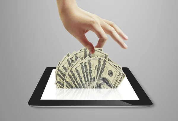 Tablet showing financial symbols coming — Stock Photo, Image