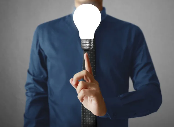 Businessman holding a Light bulb — Stock Photo, Image