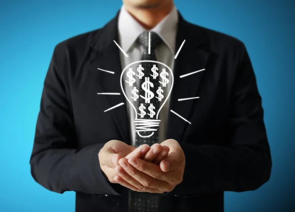 Businessman holding light bulb — Stock Photo, Image