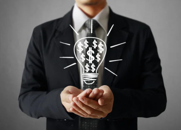 Businessman holding light bulb — Stock Photo, Image