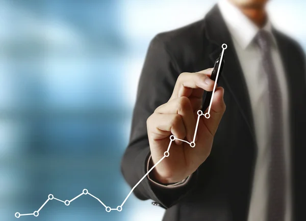 Man drawing a growing graph — Stock Photo, Image