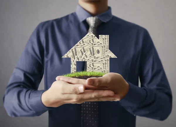 Affärsman håller hus modell — Stockfoto