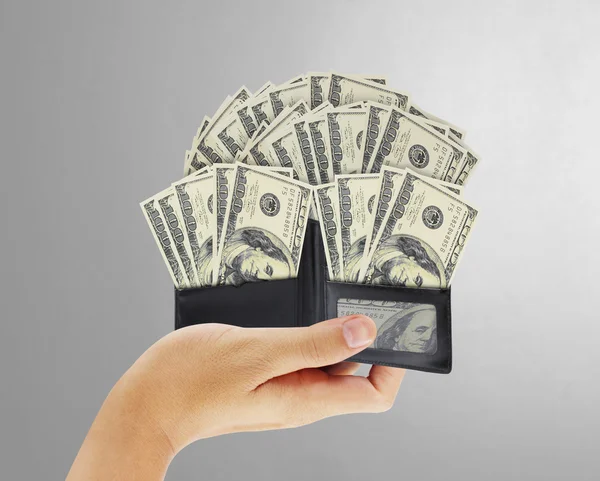 Dólar en cartera de cuero negro en la mano — Foto de Stock