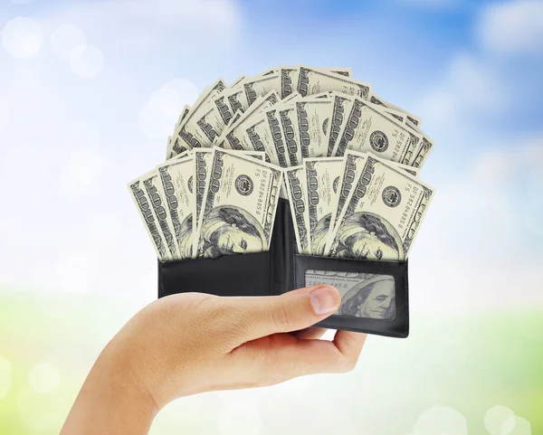 Dollar in  black leather wallet in hand — Stock Photo, Image