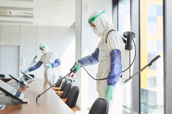 Side View Portrait Two Workers Wearing Hazmat Suits Disinfecting Conference — Stock Photo, Image