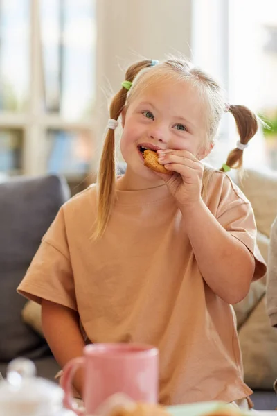 Κάθετη Πορτρέτο Του Χαριτωμένο Κορίτσι Σύνδρομο Κάτω Τρώει Μπισκότο Ενώ — Φωτογραφία Αρχείου