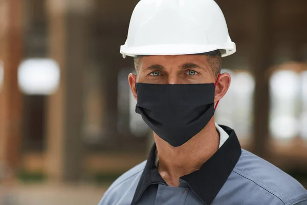 頭と肩の肖像画成熟した労働者のマスクを着用し 産業サイトで作業しながら カメラを見て スペースをコピー — ストック写真