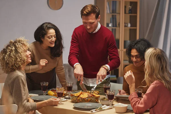 Portrait Smiling Adult Man Cutting Delicious Roasted Turkey While Enjoying — Stock Photo, Image