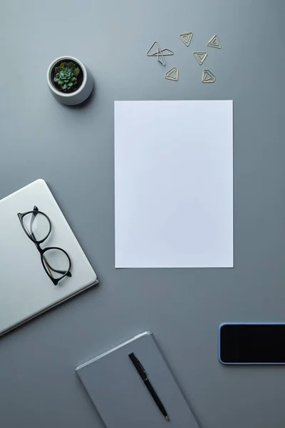 View Flat Lay Blank White Paper Grey Workplace Background Smartphone — Stock Photo, Image