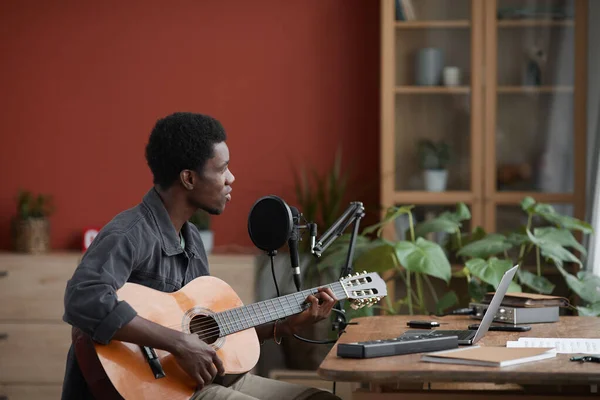 Sidovy Porträtt Ung Afro Amerikansk Man Spelar Gitarr Medan Sitter — Stockfoto