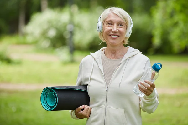 Medium Portrait Shot Happy Aged Woman Wearing White Headphones Holding — Stock Photo, Image