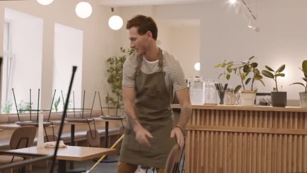 Medium Long Shot Caucasian Male Cafe Worker Tattoos Putting Chairs — Stock Video