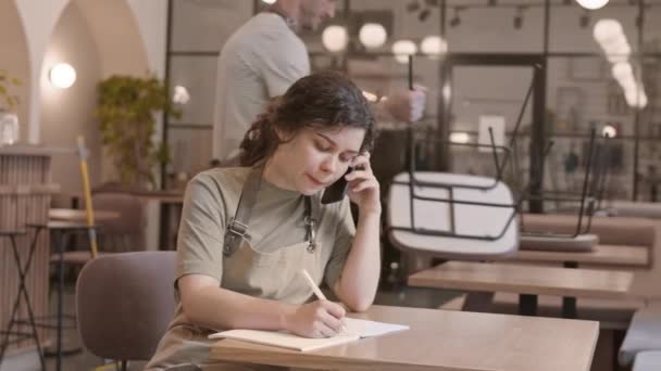Close Young Female Caucasian Cafe Worker Sitting Table Having Phone — Stock Video