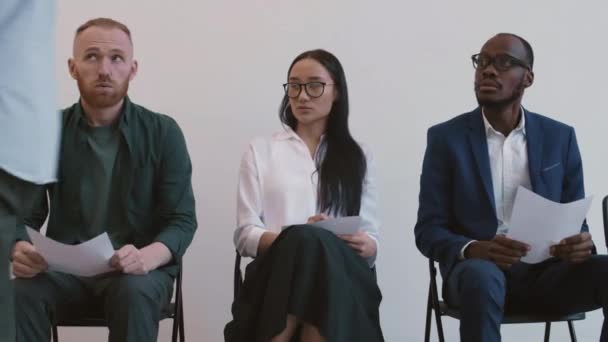 Medium Shot Three Nervous Multiethnic Job Applicants Sitting Chairs Hallway — Stock Video