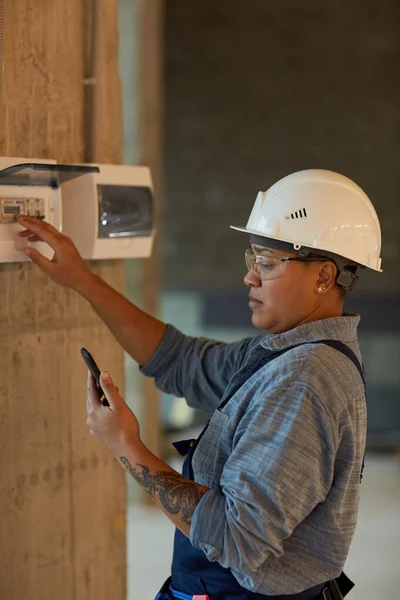 Retrato Vertical Vista Lateral Trabalhadora Montando Eletricidade Usando Smartphone Enquanto — Fotografia de Stock