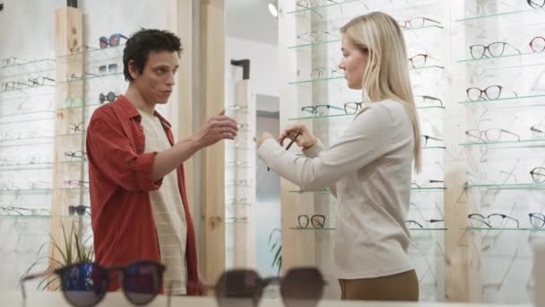 Medium Shot Blond Haired Female Optometrist Consulting Young Male Client — Stock Video